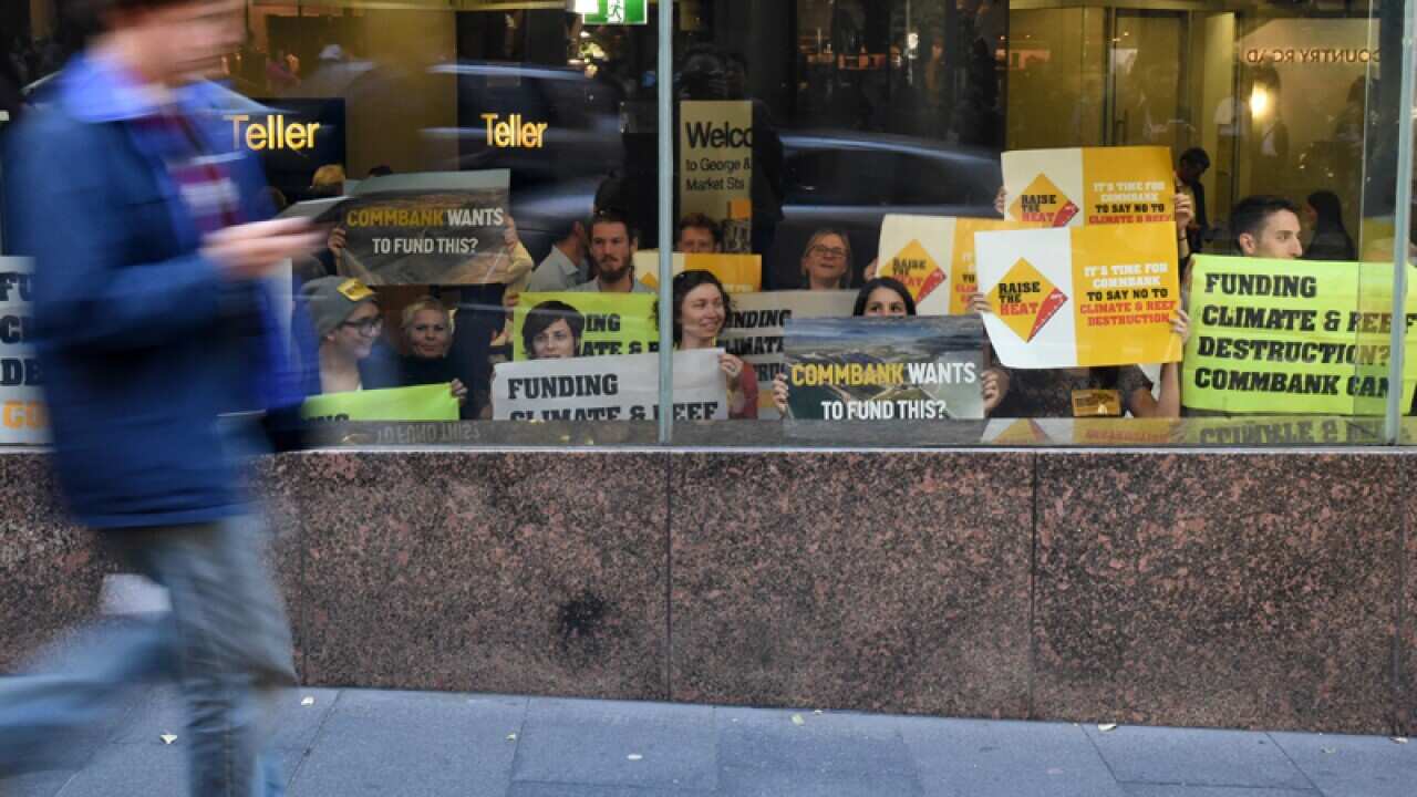 Protesters inside a Commonwealth Bank branch in Sydney's CBD