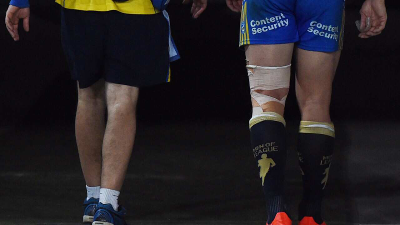Anthony Watmough of the Eels limps from the field
