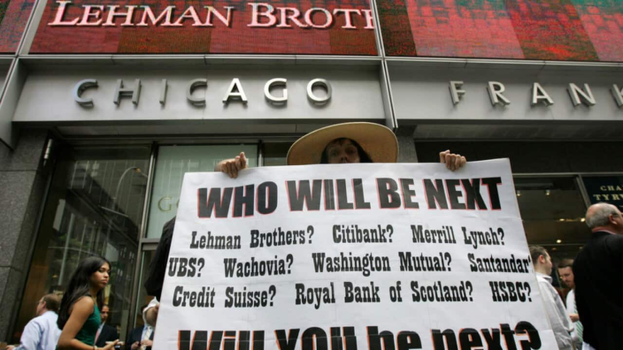 Robin Radaetz holds a sign in front of the Lehman Brothers headquarters in New York.