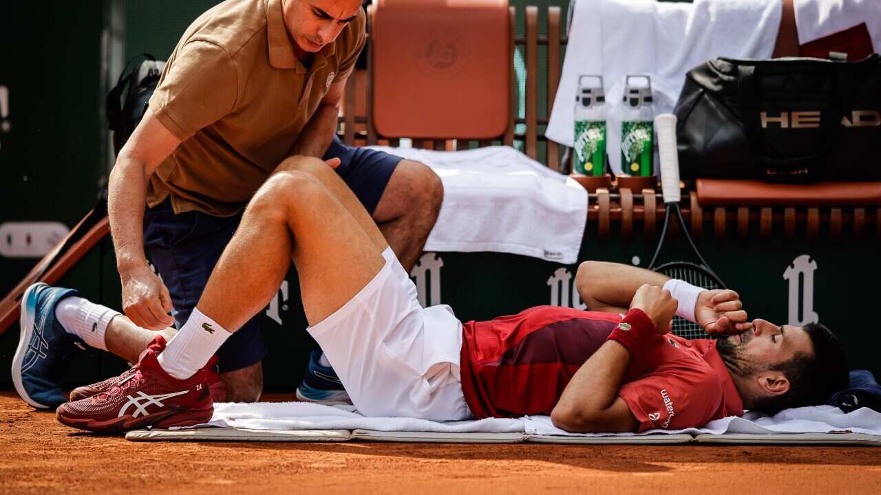 Novak Djokovic of Serbia receives medical treatment during the ninth day of Roland-Garros 2024