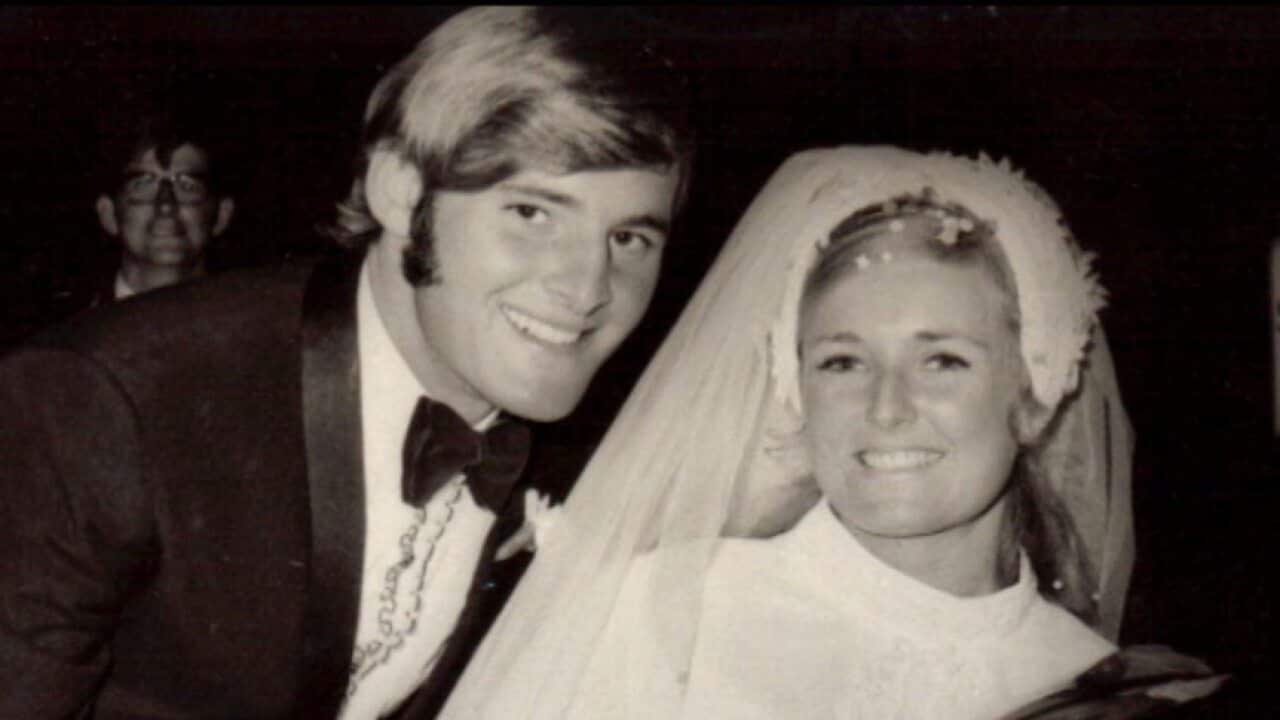 A black and white photo of a bride and groom