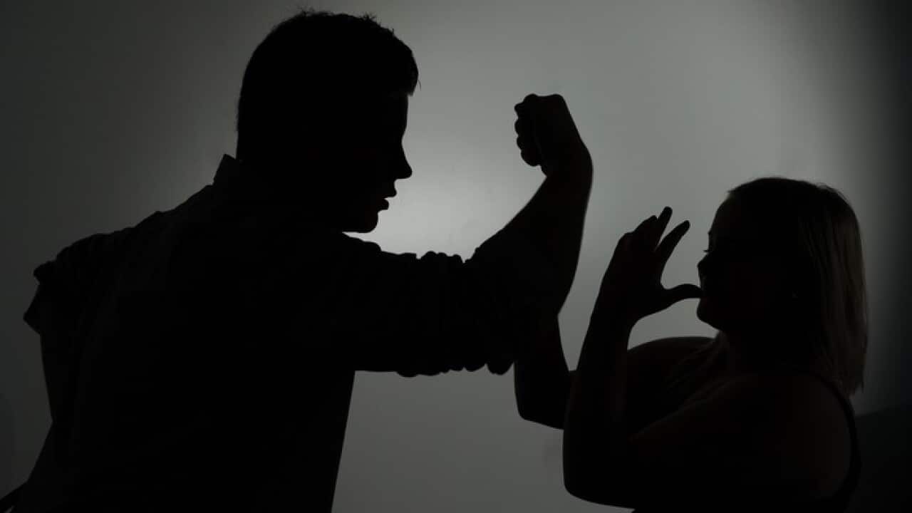 The illustration shows the silhouette of a man threatening a woman