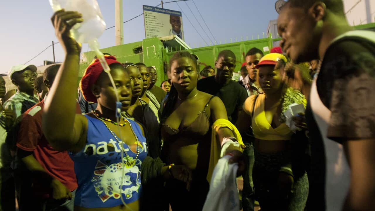 At least 20 people on a music group's packed Carnival float in the Haitian capital were killed Tuesday when they were electrocuted by a power line, officials said. ( AP Photo/Dieu Nalio Chery)
