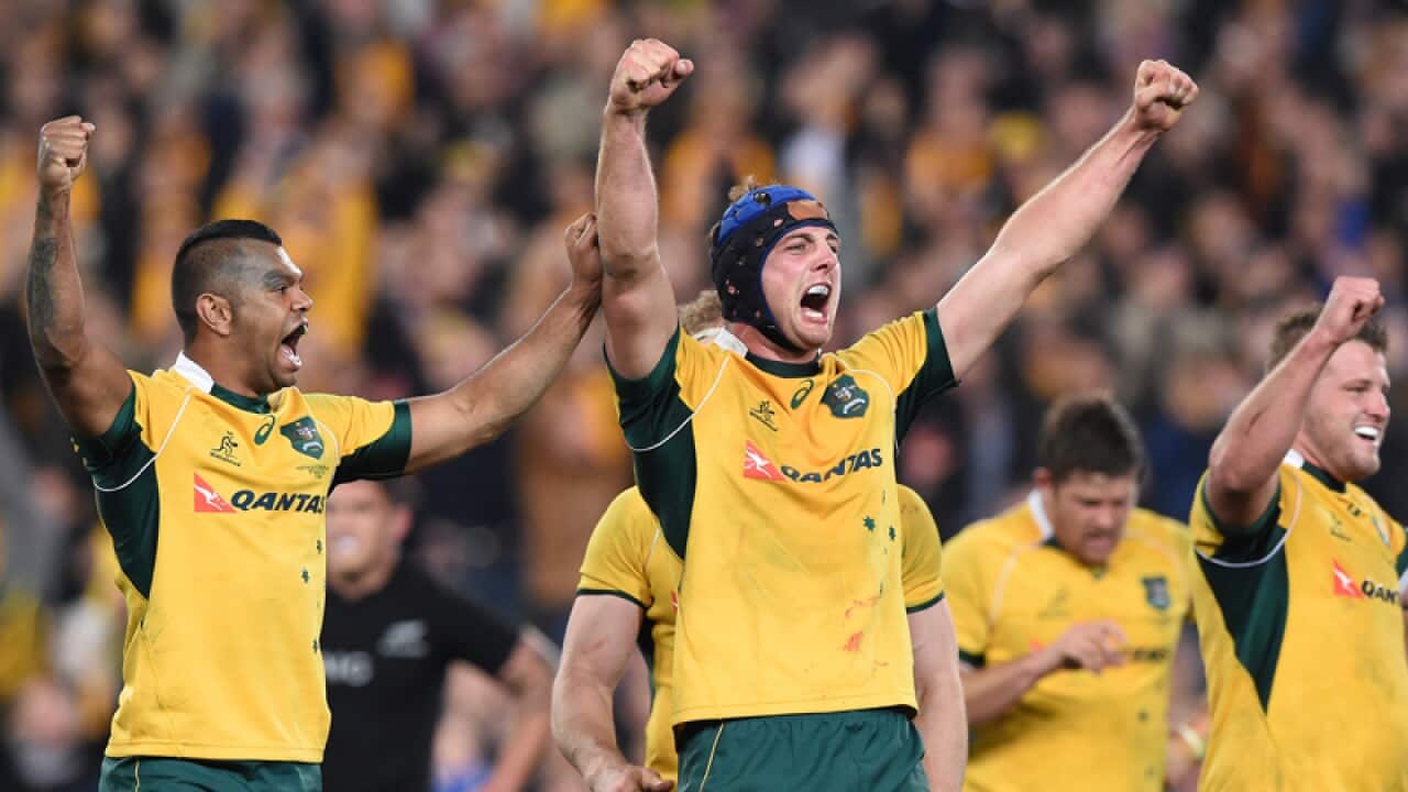 Wallabies players Kurtley Beale (left) and Dean Mumm (right) react