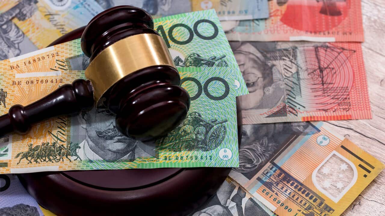 Australian dollars under judge's gavel close up