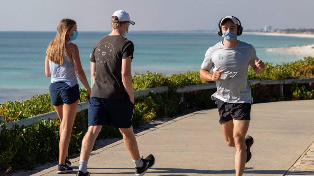 Members of the public exercise wearing masks along the foreshore at Cottesloe beach in Perth, Monday, 1 February, 2021.