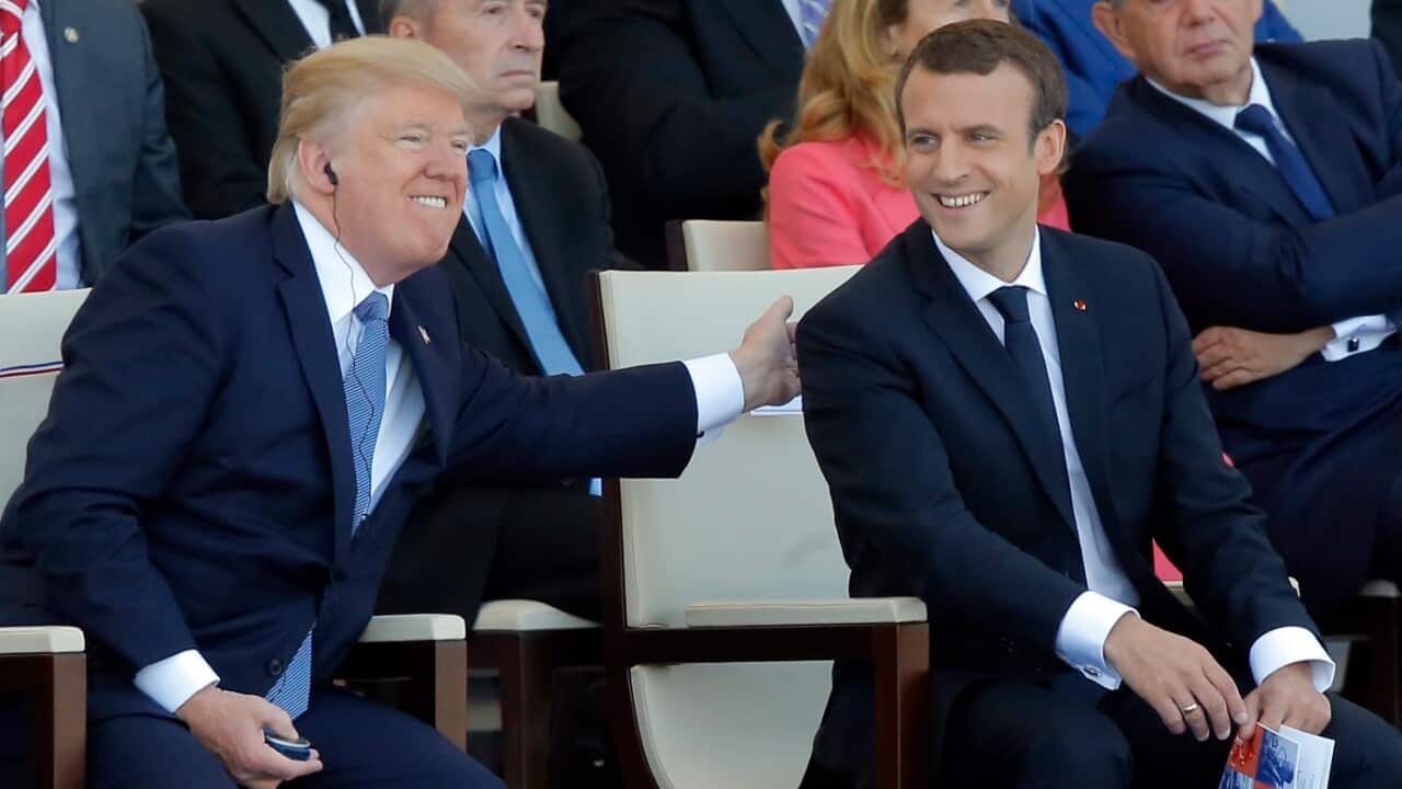 French President Emmanuel Macron, right, and US President Donald Trump attend the traditional Bastille Day military parade in 2017