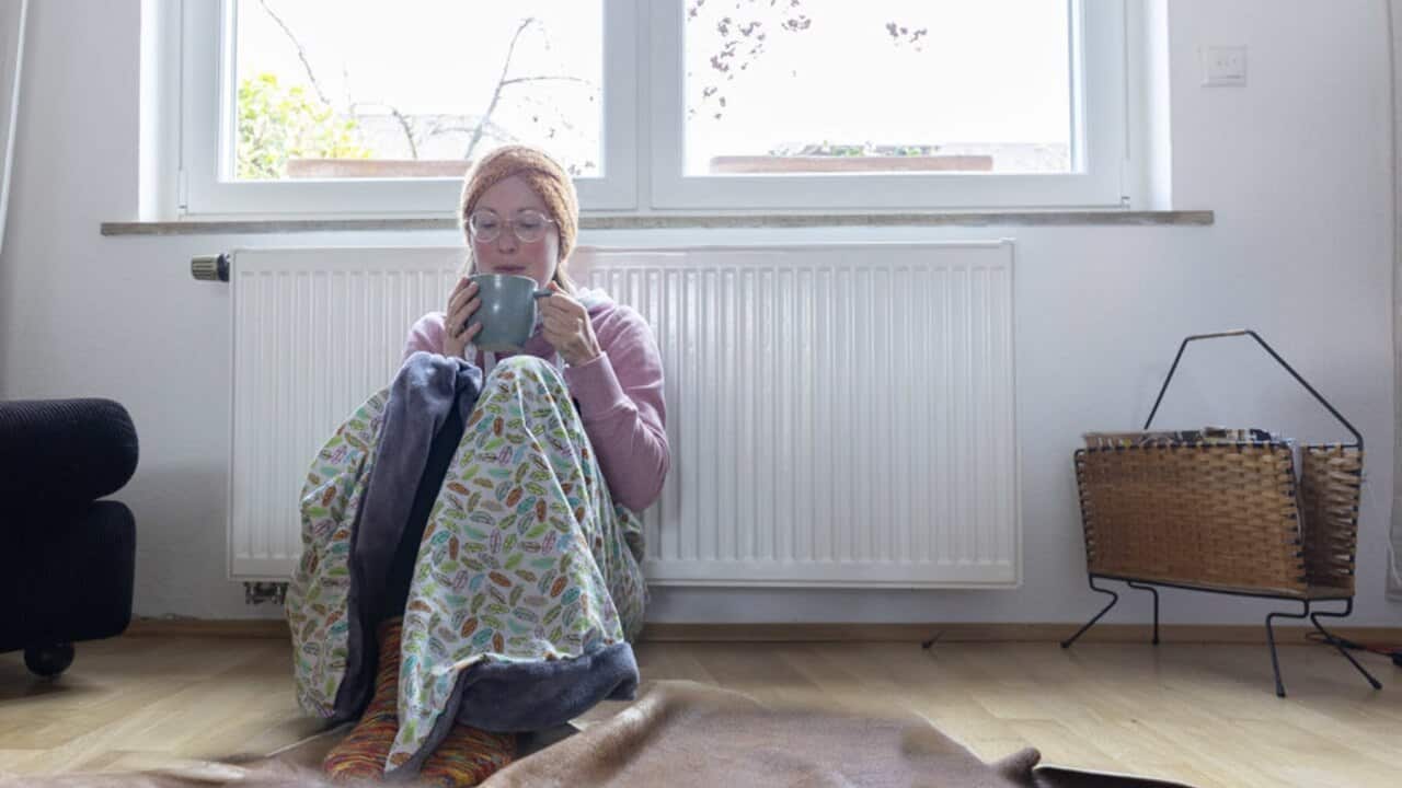A woman in front of her heater