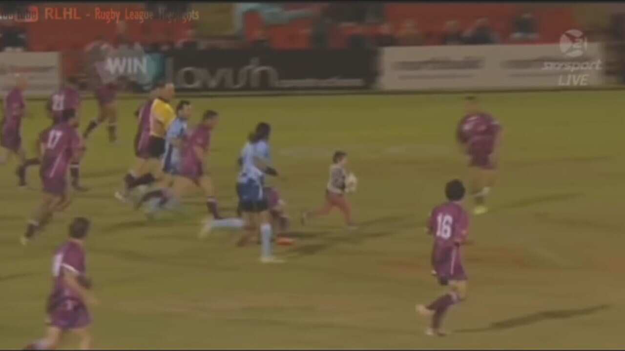 Four year old Laiken Kearns with the footy in the middle of the Legends of League State of Origin charity match (Youtube)