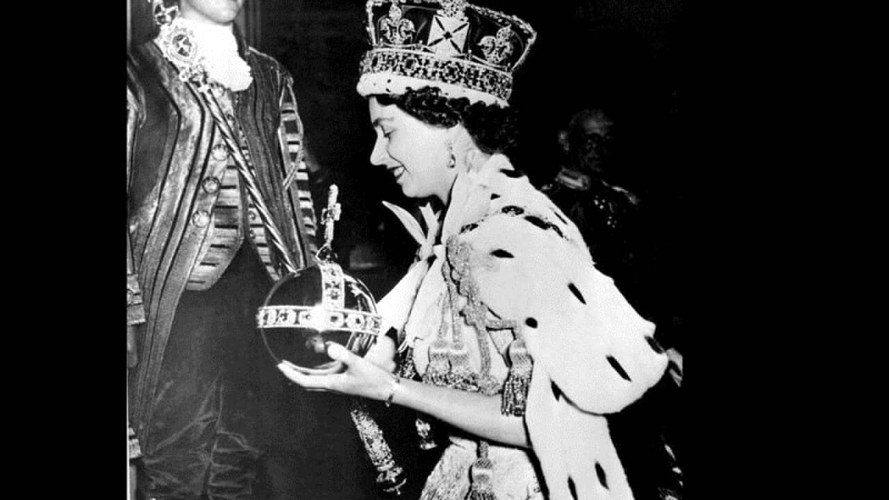 The Queen wearing her Crown, carrying the Orb and Scepter with Cross,