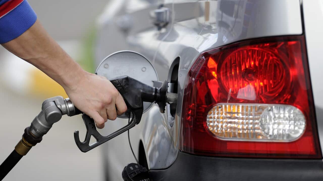 A man pumps petrol at a service station in Melbourne, Monday, Aug. 27, 2012. (AAP Image/Julian Smith) NO ARCHIVING