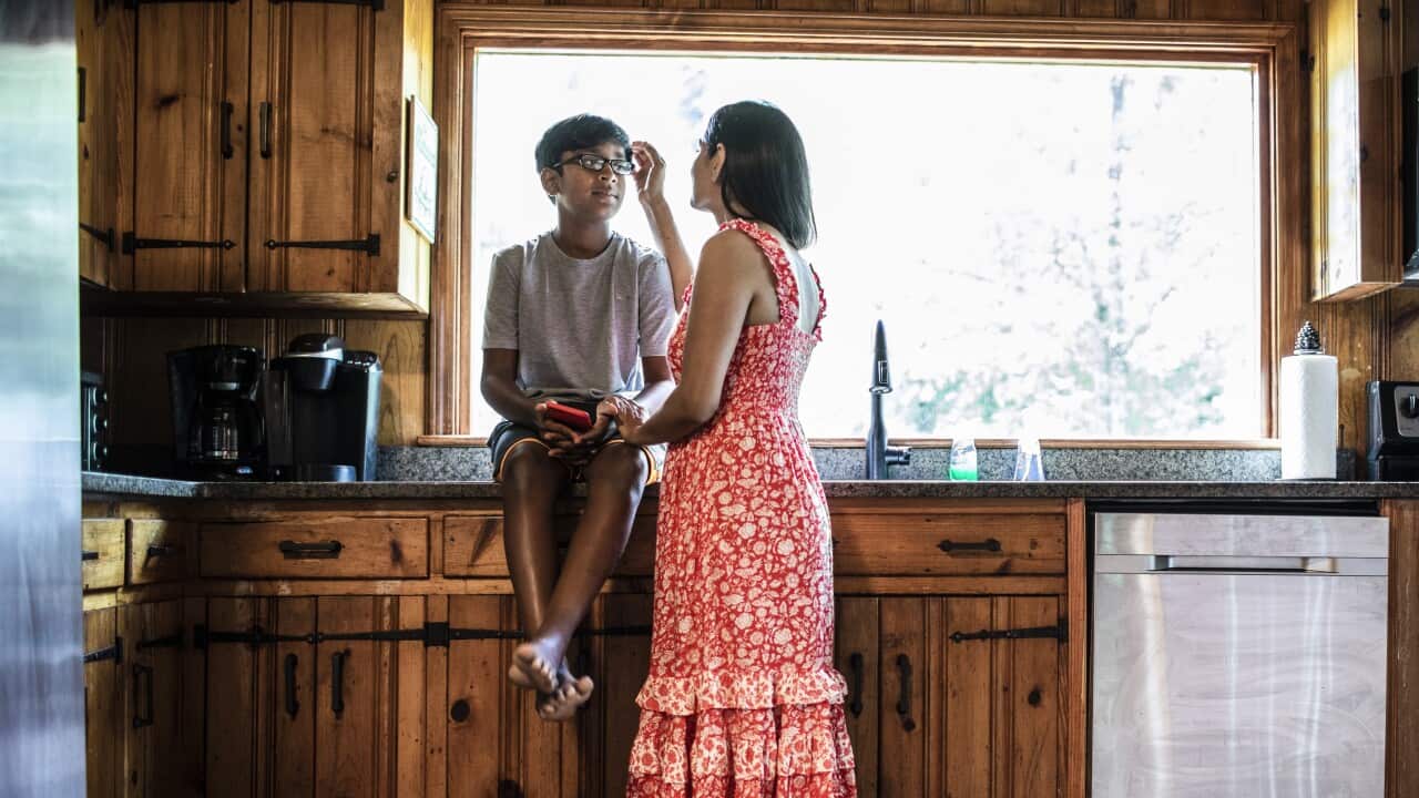 Mother comforting son at home