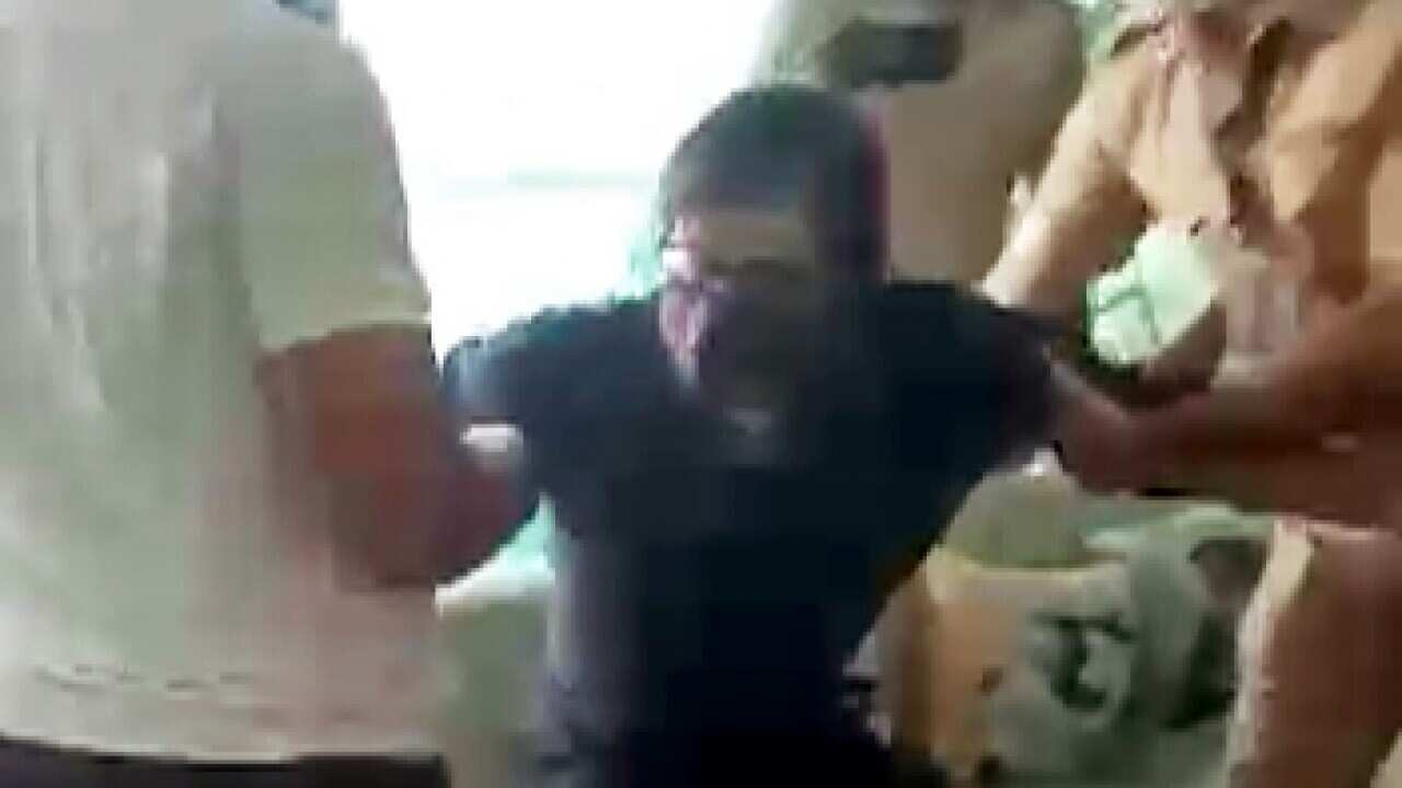 Police personnel pull Republic TV Editor Arnab Goswami as they detain him,