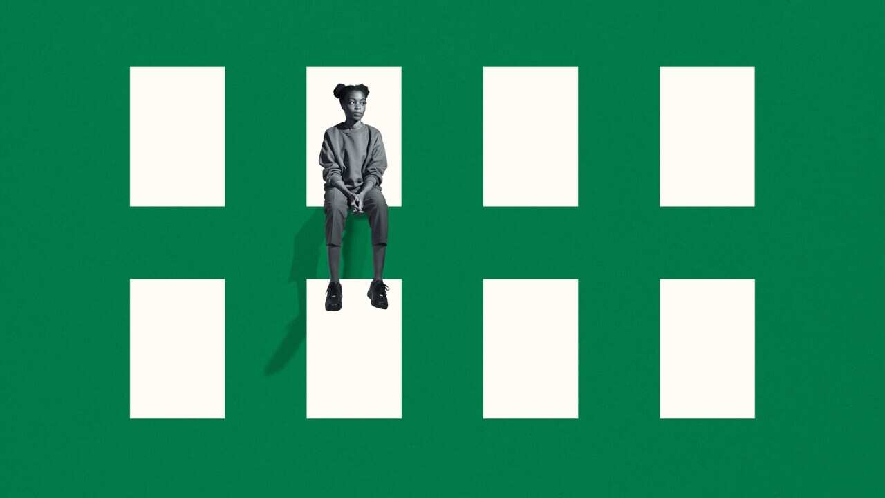 lonely young woman sitting on green grid window