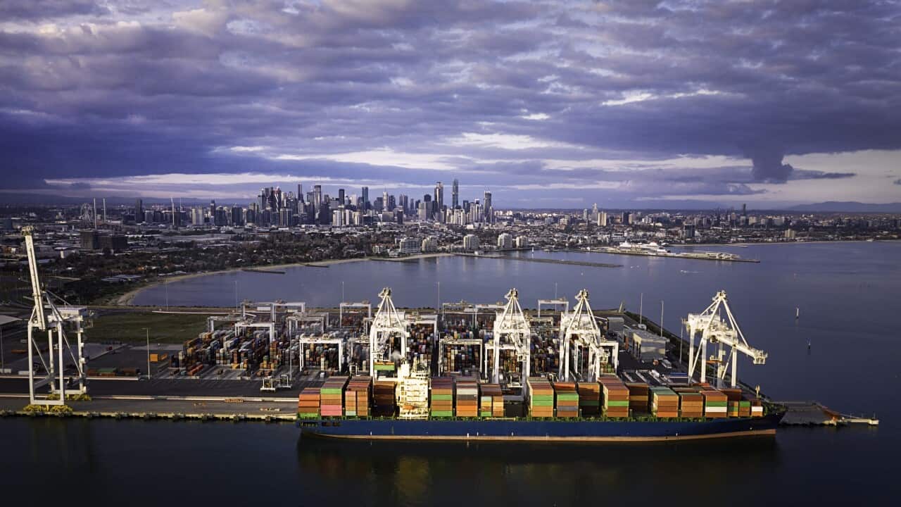Aerial view of a cargo boat and the Melbourne Skyline