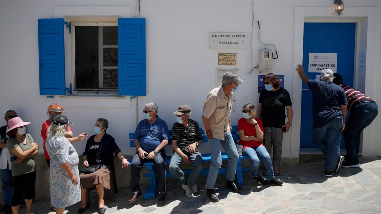 Local residents wait for their second dose of the Pfizer vaccine against COVID-19 on the tiny Aegean island of Iraklia, Greece