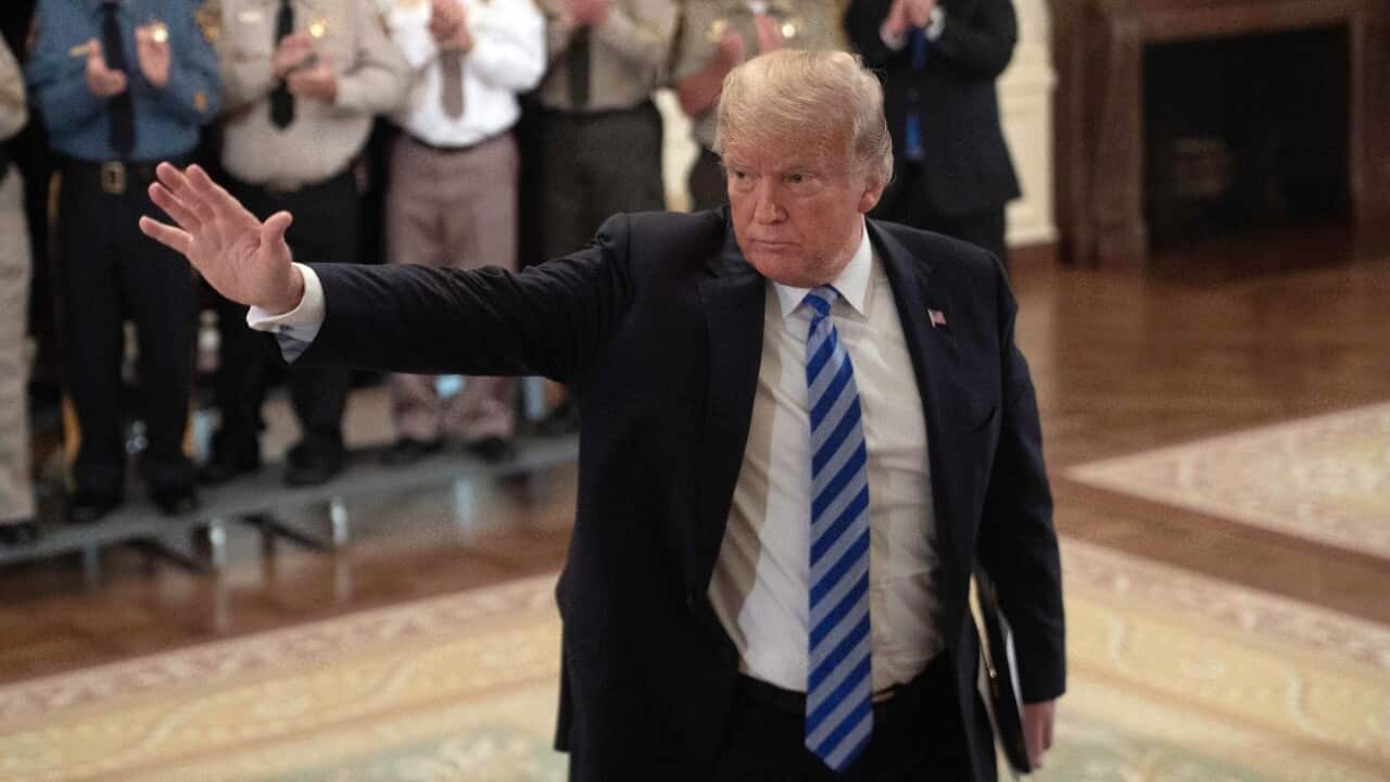 US President Donald Trump waves during a meeting with sheriffs from across the US at the White House in Washington, DC, on September 5, 2018.