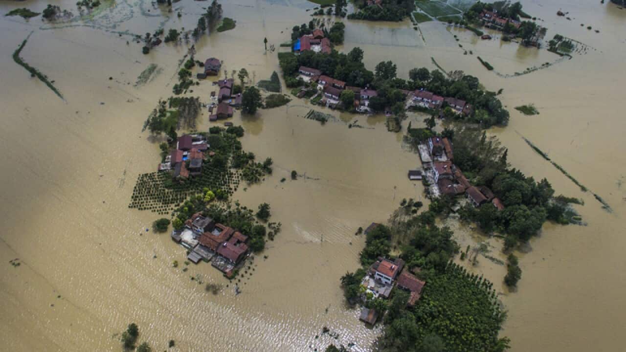 Village houses and field partially submerged by floodwaters