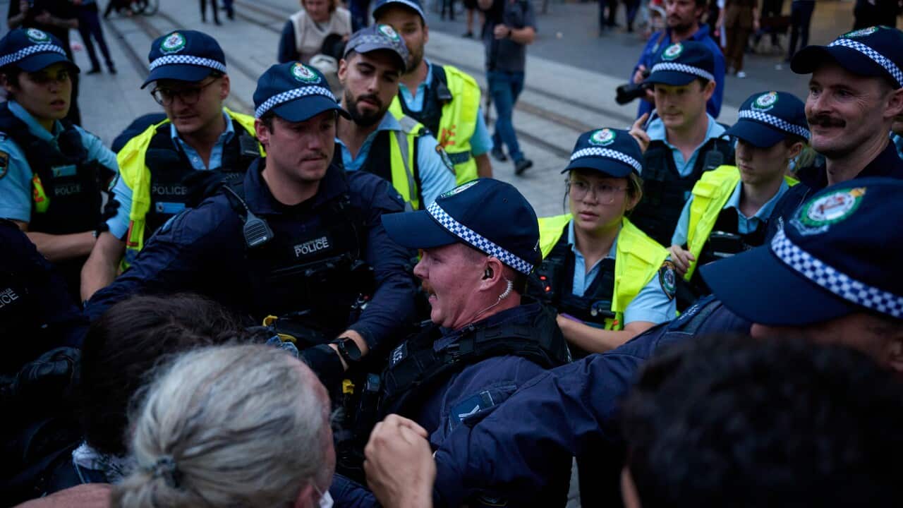 Police officers clash with protesters