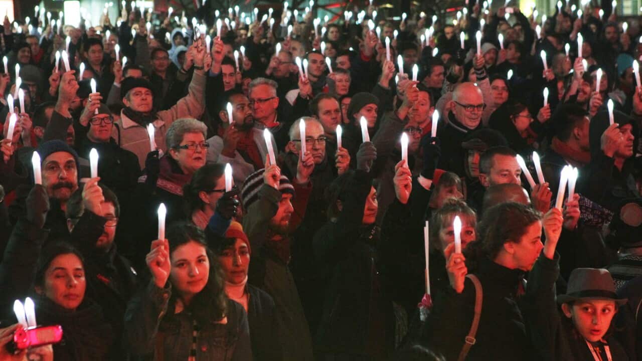 Delegates and supporters from the Aids 2014 conference in Melbourne hold a candlelight vigil in Federation square to remember their colleagues who were killed in MH17. (AAP)