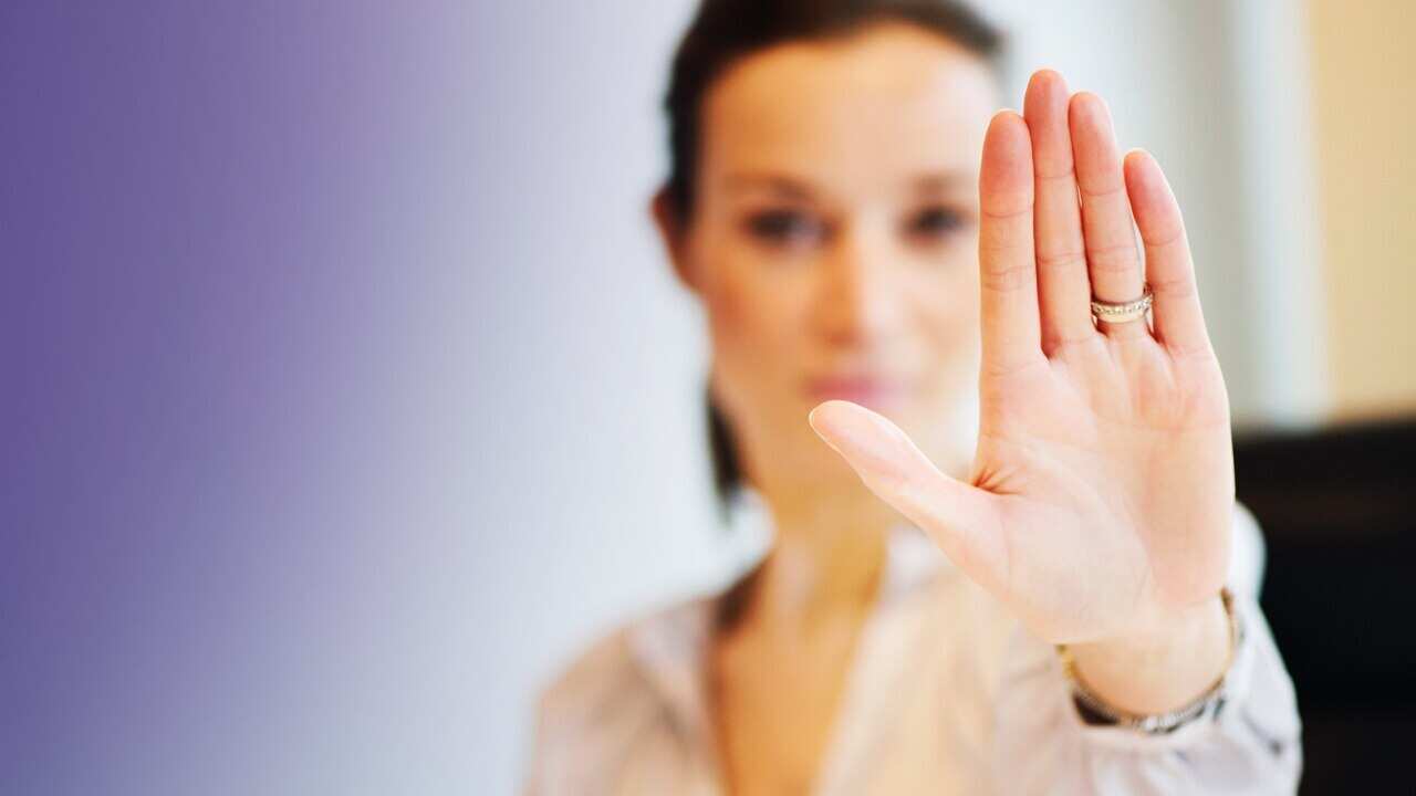 Women with her hand up. 'Stop'