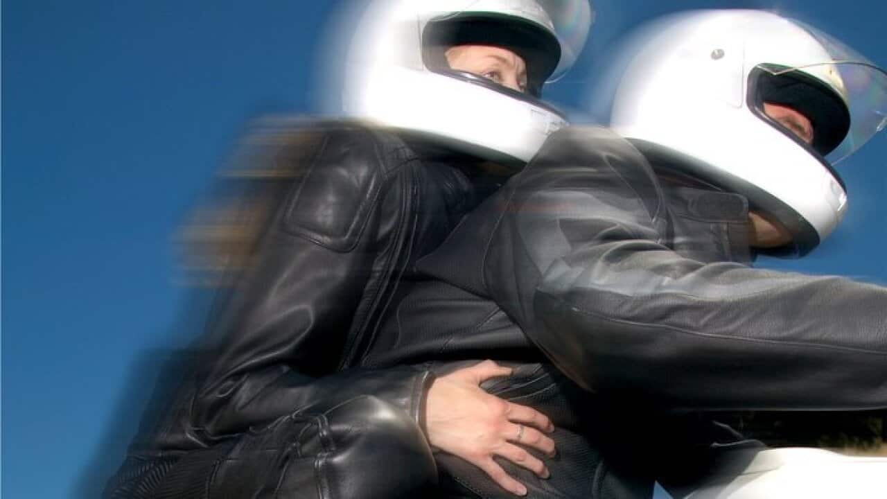 Man and woman on motorcycle