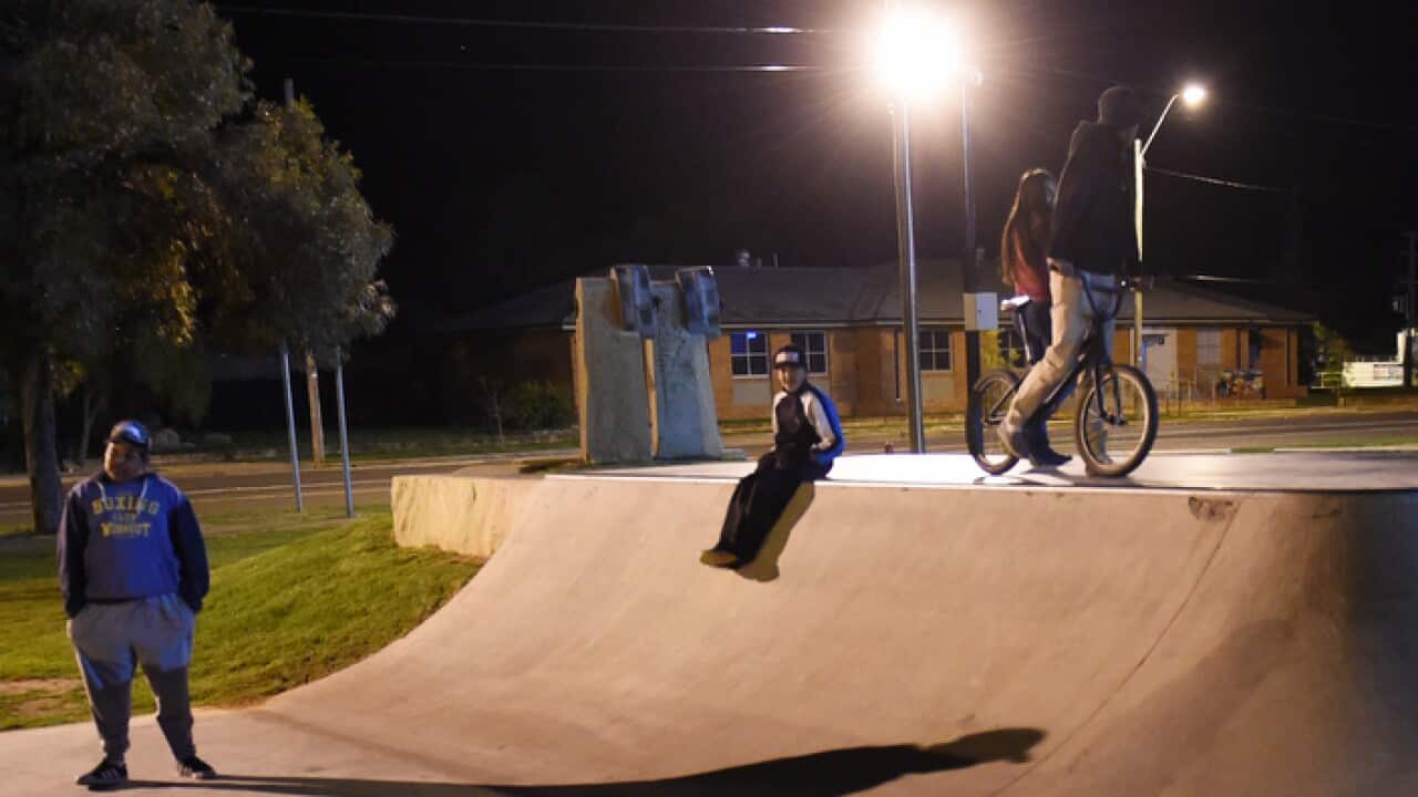 Aboriginal youths at a skate park at night in the NSW outback town of Bourke.
