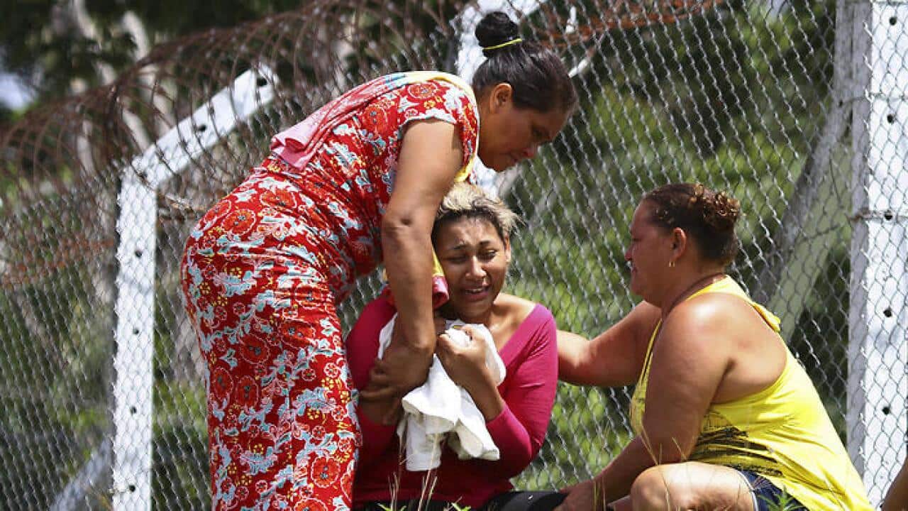 The wife of a prisoner who was killed in a prison riot, cries outside the Anisio Jobim Penitentiary Complex in Manaus, Brazil, Monday, Jan. 2, 2017