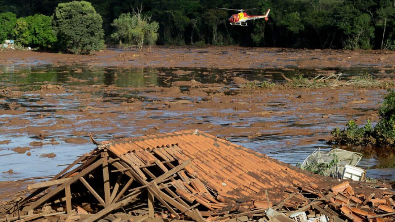 Rescue workers in helicopter search for survivors