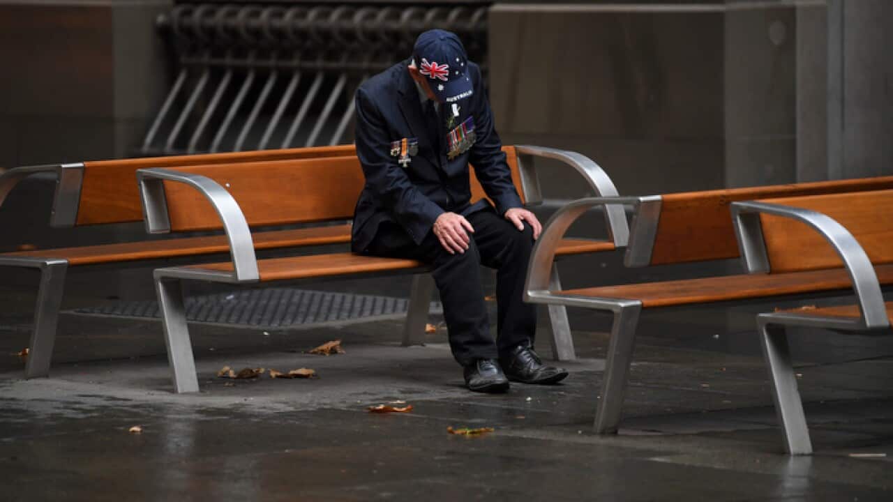 An elderly man sits after attending an Anzac Day Dawn Service in Sydney