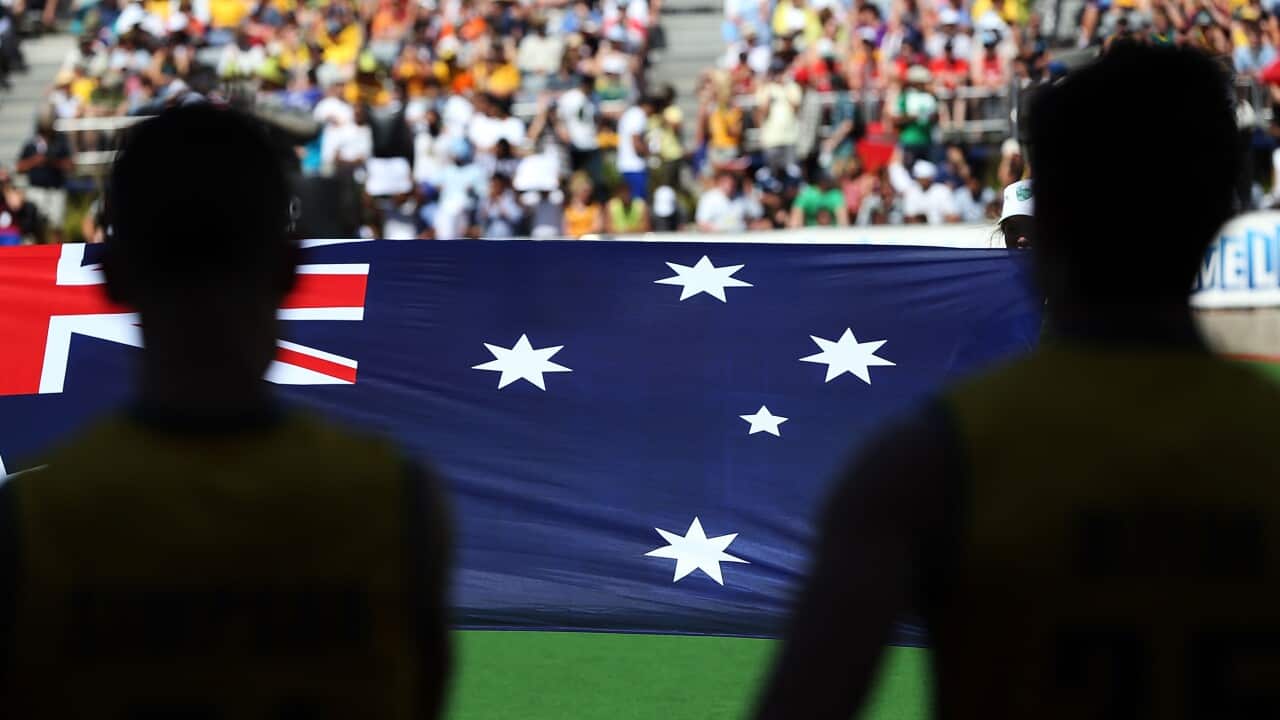 File, Melbourne, December 2012, The Australian flag held up during the Australian National Anthem before a cricket match.