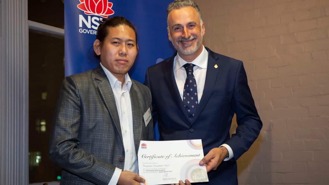 Thupten Tashi (left) receives his interpreting qualification from the NSW multicultural minister, John Sidoti