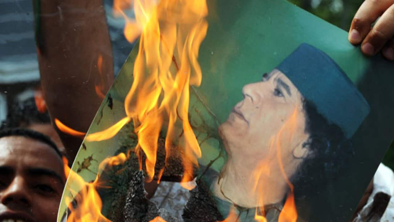 Gaddafi-pic-on-fire_B_Getty_1572096451