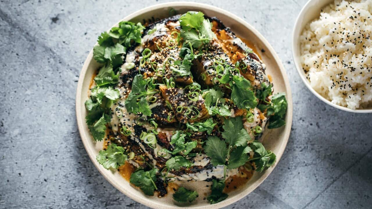 Split roast cabbage served with rice