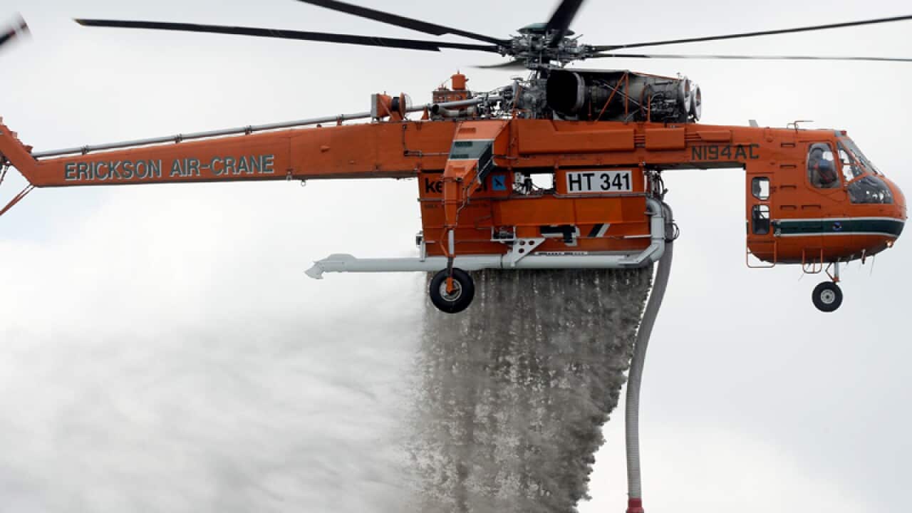 An aircrane demonstrates its water bombing skills