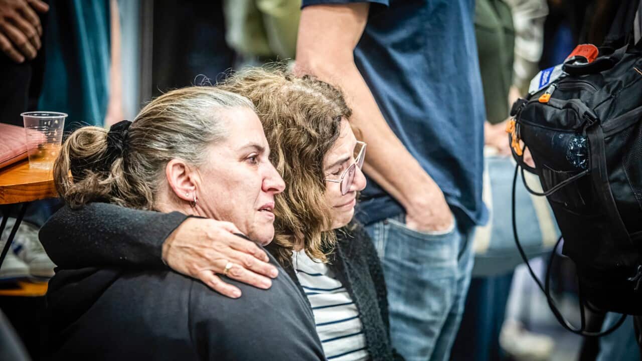 Two women hugging each other