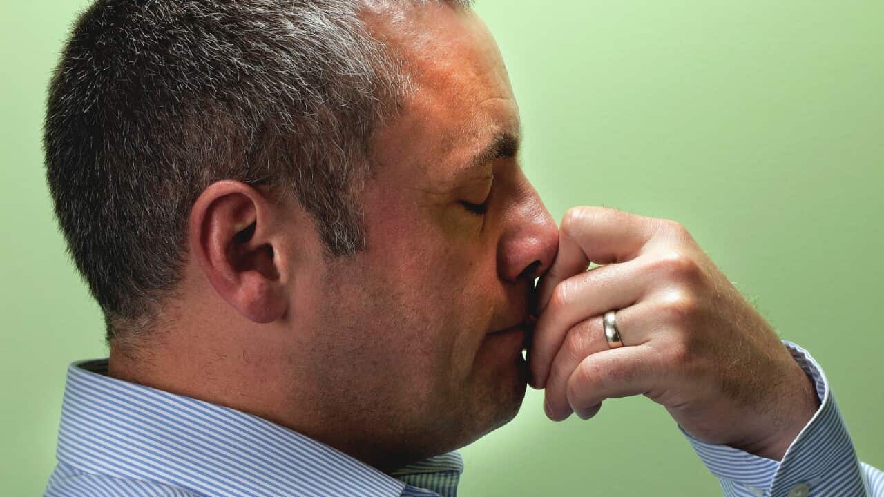 Mature male teacher with hand on chin