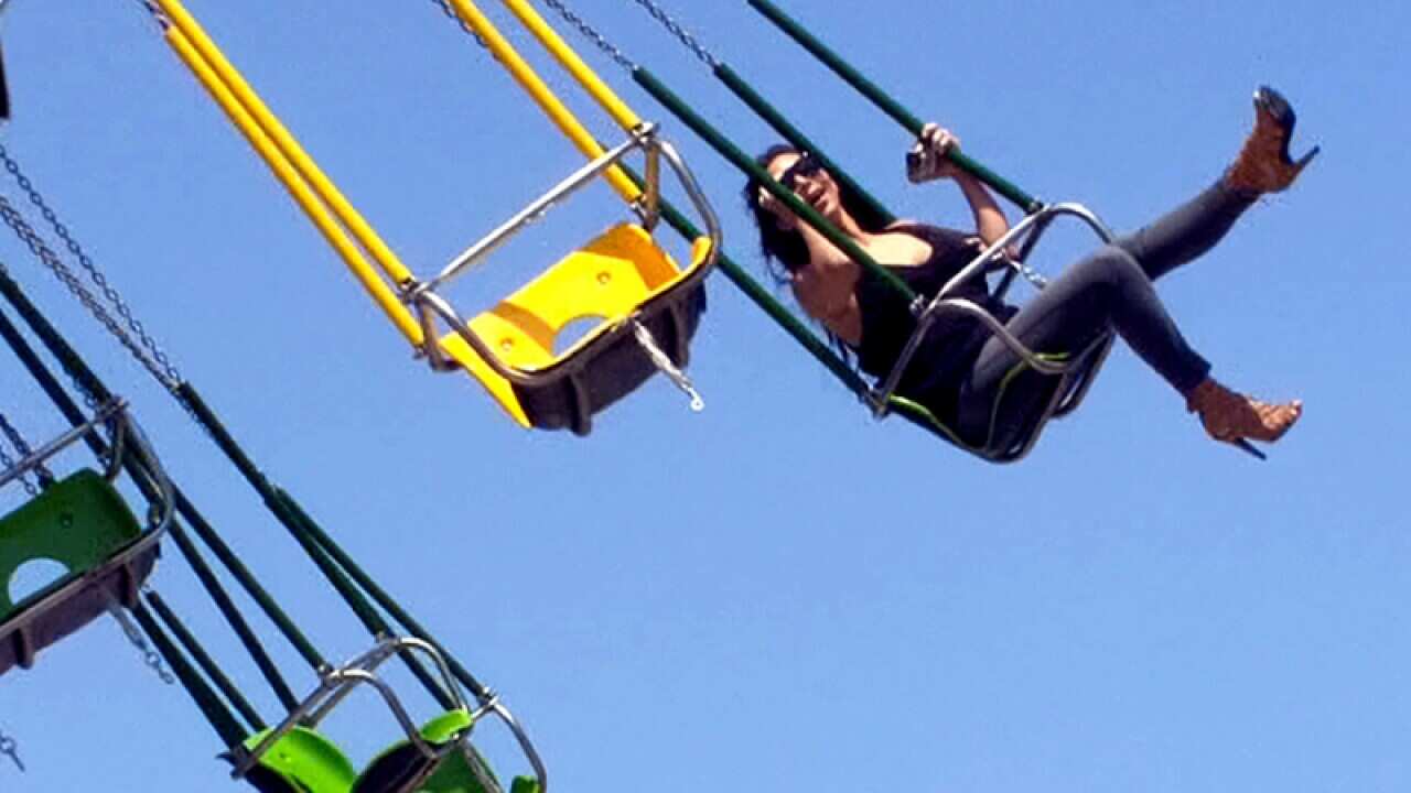 Kim Kardashian rides on the Casino Pier swings