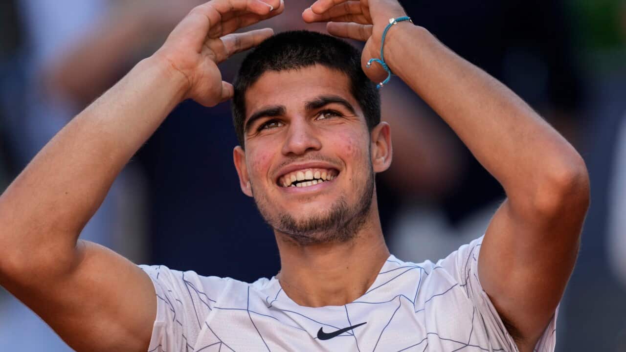Spain's Carlos Alcaraz celebrates after winning a match against Spain's Rafael Nadal at the Mutua Madrid Open tennis tournament in Madrid, Friday, May 6, 2022. (AP Photo/Bernat Armangue)