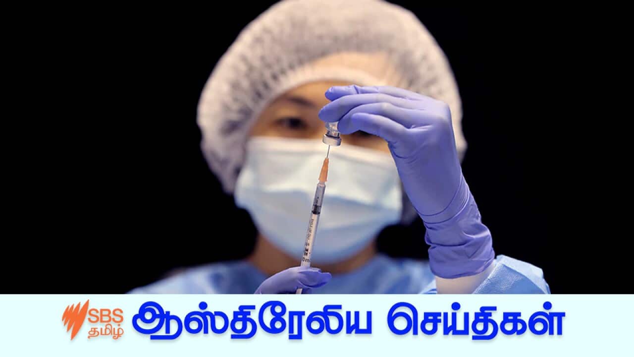 A health care worker fills a syringe with the Pfizer vaccine.