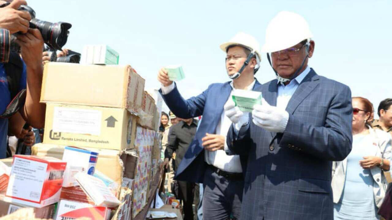 Cambodia Interior Minister Sar Kheng is checking the fake products