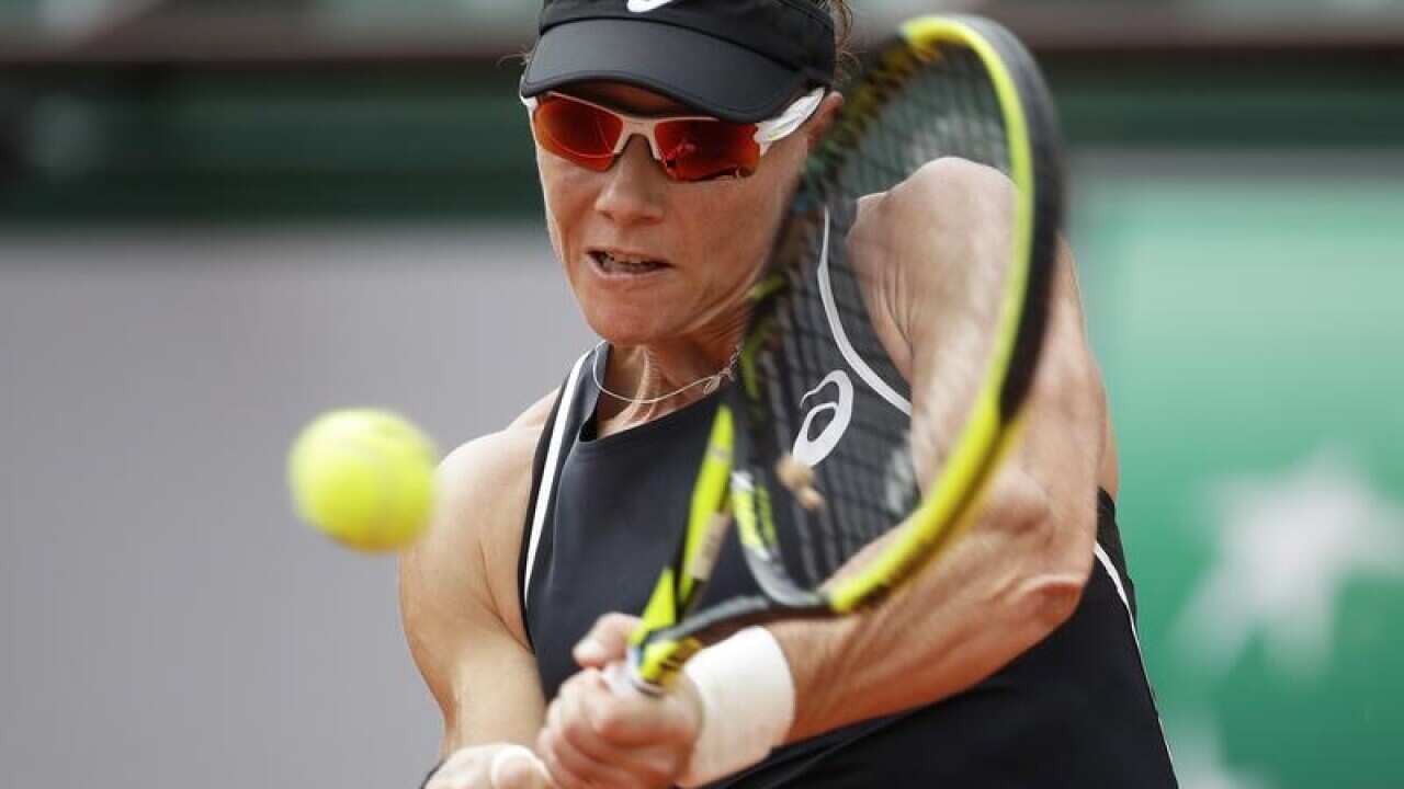 Australia's Samantha Stosur returns against Spain's Garbine Muguruza.