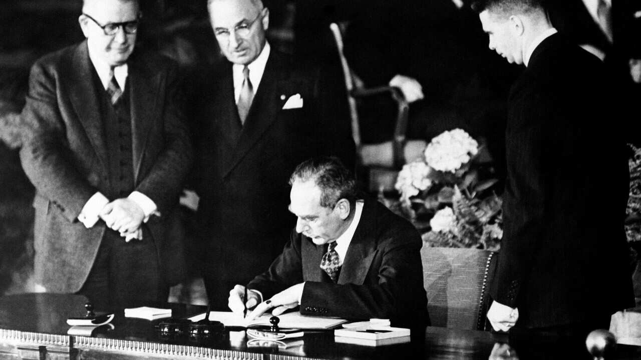 thumbnail_Watched by President Harry Truman, US Secretary of State Dean Acheson signs the North Atlantic Treaty, along with Foreign Ministers from 12 nations (Getty).jpg