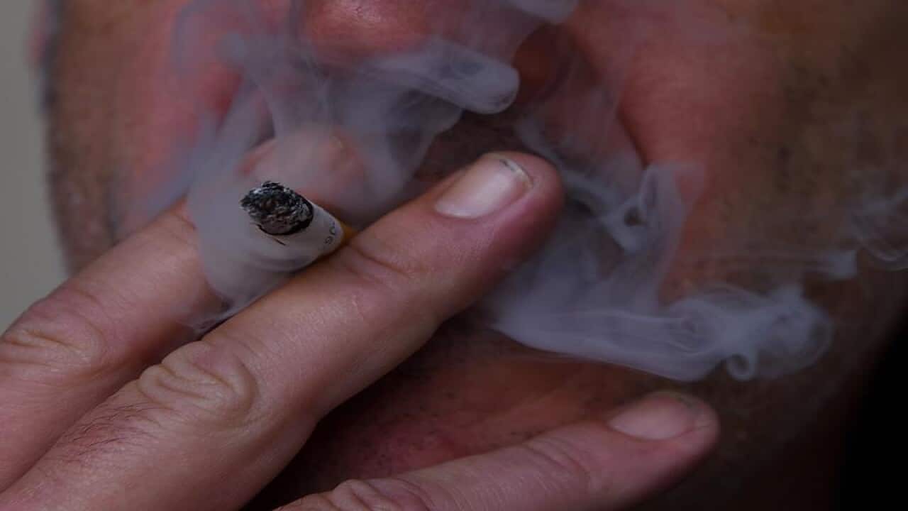 This is a file stock image of a man smoking a cigarette.