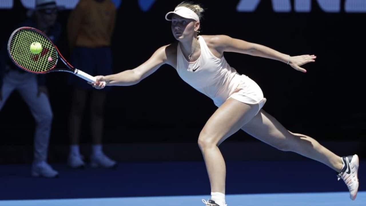Ukraine's Marta Kostyuk reaches for a forehand return to Australia's Olivia Rogowska during their second round