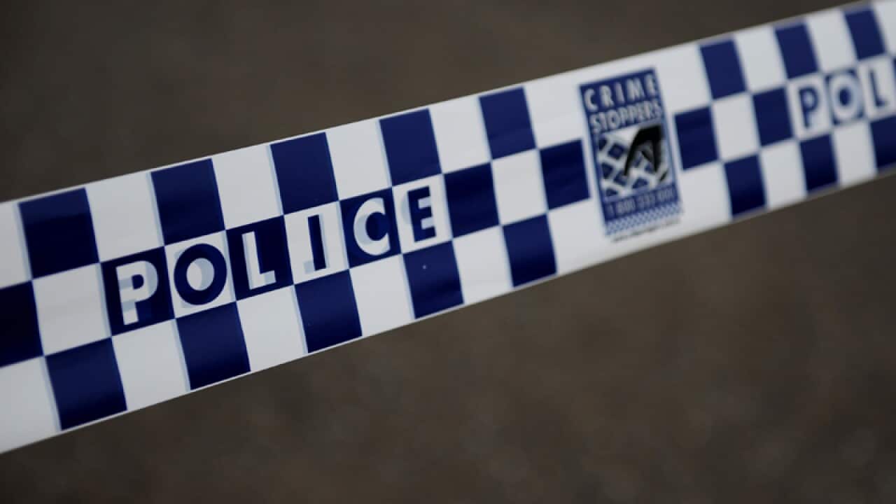 Police tape cordons off a scene.