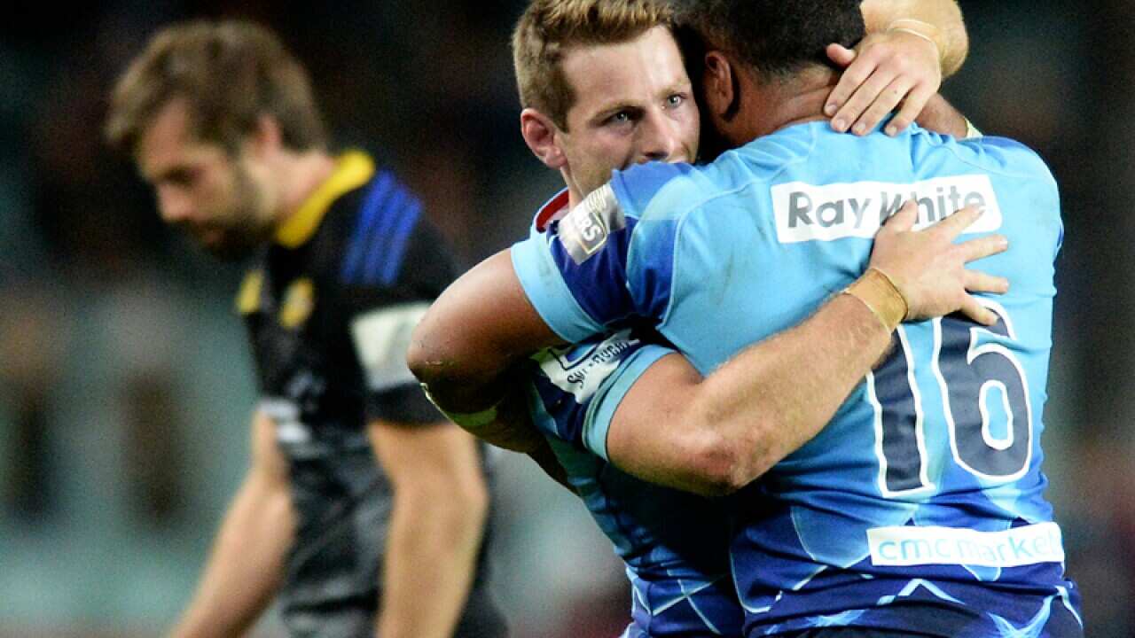 The Waratahs Bernard Foley celebrates with Tolu Latu.