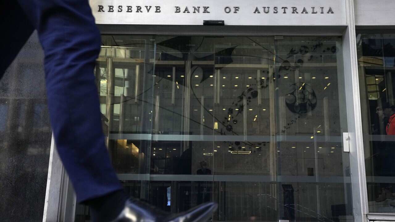 AustA man walks past the Reserve Bank of Australia in Sydney (AAP).