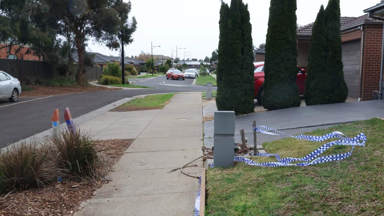 Crime tape on a front lawn