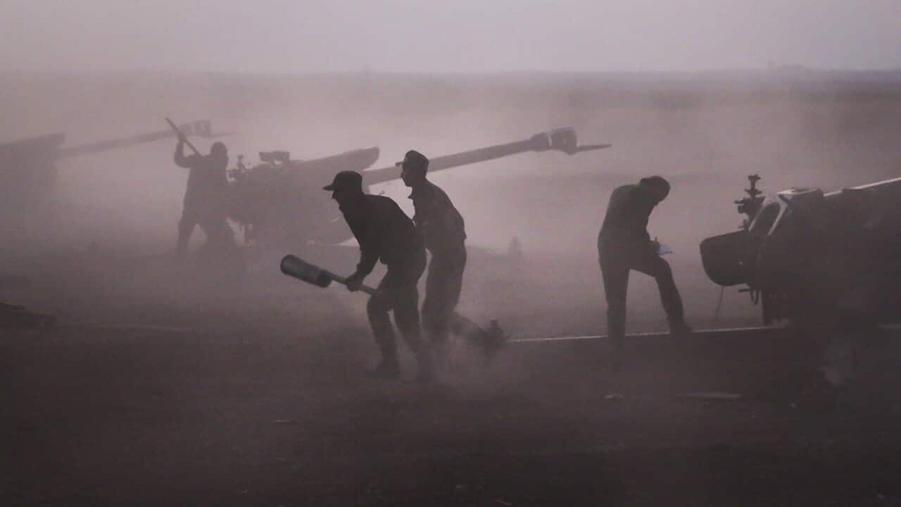 Syrian army personnel load howitzers near the village of Morek, Syria 